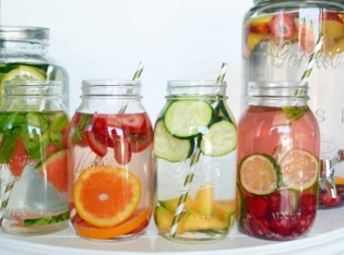 Jars of water with fruit and straws